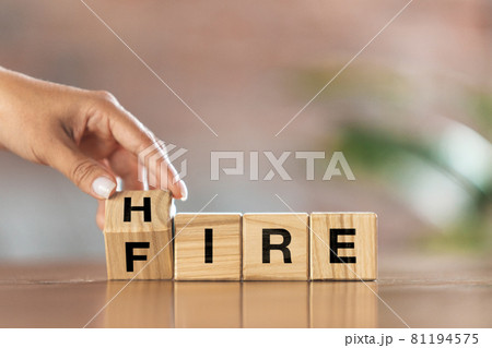 Children's cubes, blocks with word FIRE in female hand. Conceptual image about human rights, education, social issues, mental health, education and personal development. 81194575