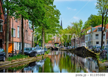 Cars on canal embankment in street of Delft. Delft, Netherlands Cars on canal embankment in street of Delft. Delft, Netherlands 81195060