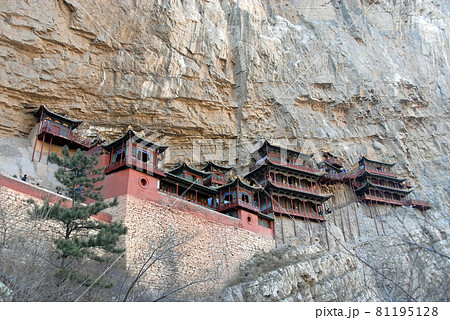 The Hanging Temple or Hanging Monastery near Datong in Shanxi Province, China. View of the Hanging Temple with trees in the foreground. The temple is a major tourist sight near Datong. 81195128