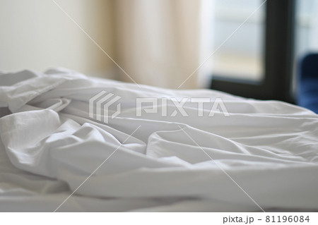 Unmade bed with crumpled bed sheet Unmade bed with crumpled bed sheet 81196084