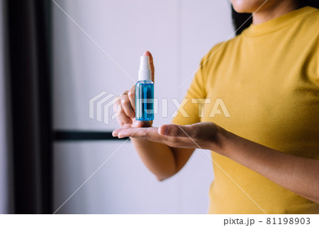 Woman hands holding sanitizer gel in spray bottle for hand hygiene coronavirus protection 81198903