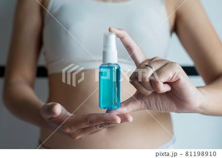 Woman hands holding sanitizer gel in spray bottle for hand hygiene coronavirus protection Woman hands holding sanitizer gel in spray bottle for hand hygiene coronavirus protection 81198910