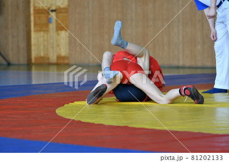 Two boys compete on the wrestling mat Two boys compete on the wrestling mat 81202133