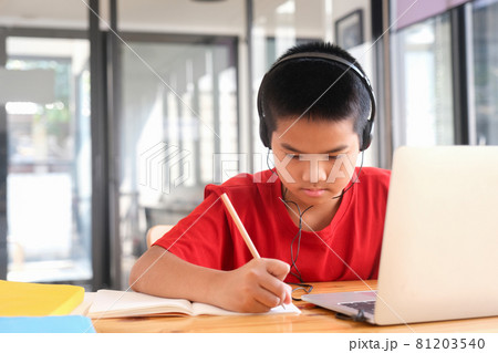 Young collage student using computer and mobile device studying online. 81203540