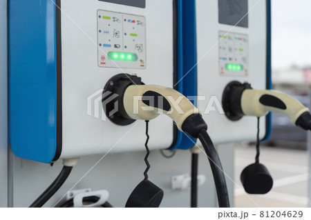 Cable from EV car charger or electric vehicle station. Cable connected at gas station, power supply battery charging an alternative eco environment future technology energy innovation 81204629