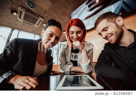 a crazy portrait of a group of entrepreneurs sitting in a modern office. 81206087