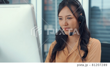 Businesswoman wearing headset working actively in office 81207289