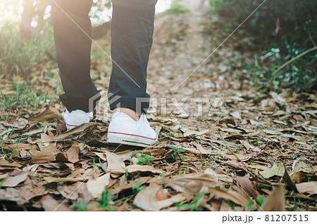 Man is walking into the wood or jungle nature walk way with sunlight.Slow life lifestyle. 81207515