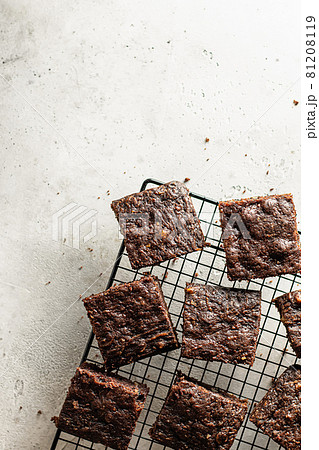 Sliced Zucchini brownie on baking rack on gray textured background 81208119
