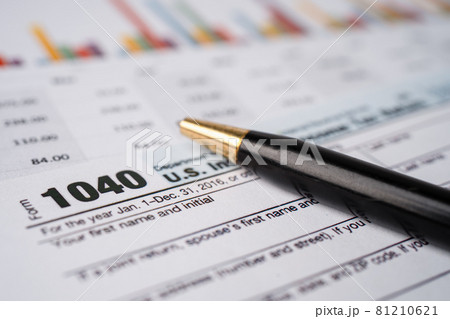 Tax Return form 1040 and dollar banknote, U.S. Individual Income. Tax Return form 1040 and dollar banknote, U.S. Individual Income. 81210621