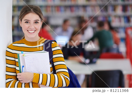 the student uses a notebook and a school library 81211366