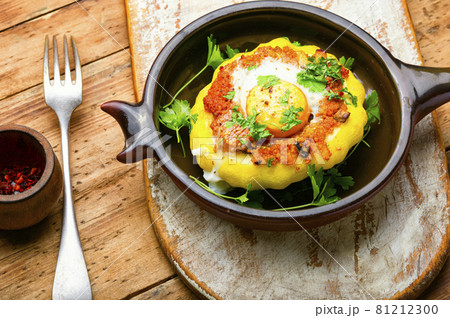 Baked stuffed patisson on rural wooden table Baked stuffed patisson on rural wooden table 81212300