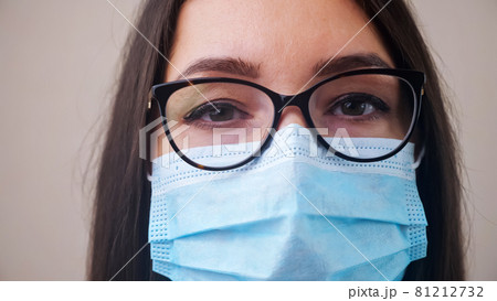 Doctor with glasses and protective mask poses for camera 81212732