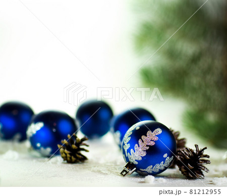 blue Christmas balls on white background with fir cones 81212955
