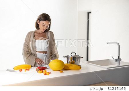 Woman cooking healthy food at modern kitchen Woman cooking healthy food at modern kitchen 81215166