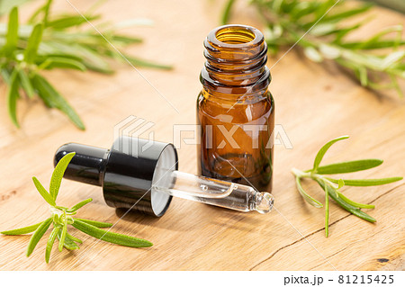 Rosemary essential oil on wooden table still life. Herbal remedies Rosemary essential oil on wooden table still life. Herbal remedies 81215425