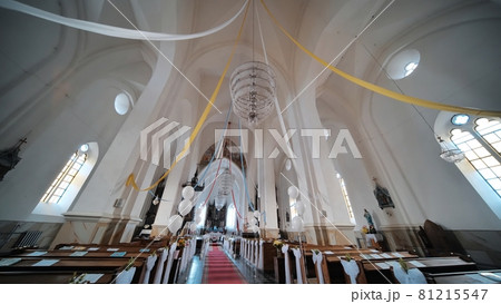The interior of a Catholic church with white balloons before the service. 81215547