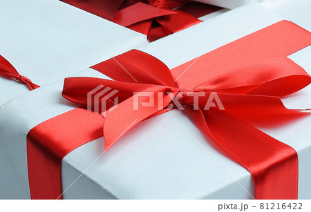 Elegant gift boxes with red satin ribbon wrapped in paper. Elegant gift boxes with red satin ribbon wrapped in paper. 81216422