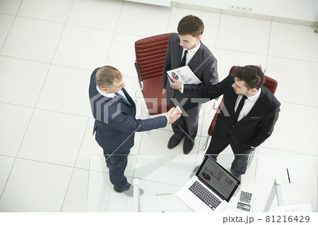 top view.handshake of financial partners before the business meeting top view.handshake of financial partners before the business meeting 81216429