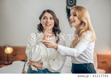Young woman talking with a real estate agent about renting an apartment and looking involved Young woman talking with a real estate agent about renting an apartment and looking involved 81217748