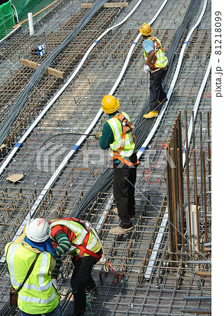 MALACCA, MALAYSIA -APRIL 14, 2016: Pre-stress cable laid in round ducting install in between the slab steel reinforcement bar at the construction site. Installed by workers.     81218099