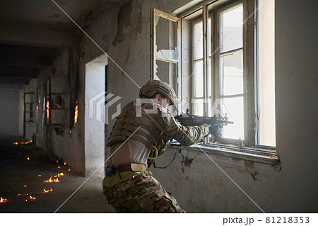 soldier in action near window changing magazine and take cover soldier in action near window changing magazine and take cover 81218353