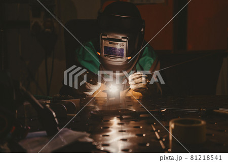 Professional welder performs work with metal parts in factory, sparks and electricity. Industry worker banner. Professional welder performs work with metal parts in factory, sparks and electricity. Industry worker banner. 81218541