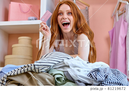Online payment,woman holding credit card for shopping online fashion, sitting behind table Online payment,woman holding credit card for shopping online fashion, sitting behind table 81219672