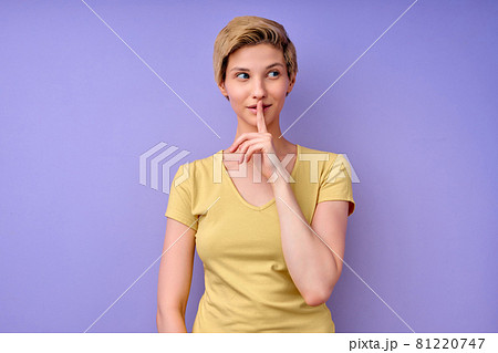Young caucasian woman keeping finger on mouth asking to be quiet, keep silence Young caucasian woman keeping finger on mouth asking to be quiet, keep silence 81220747