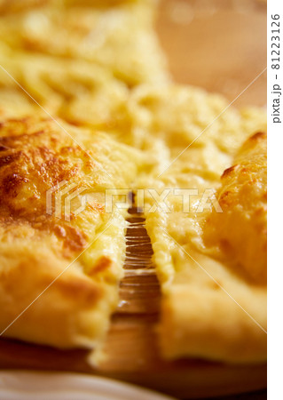 Hot khachapuri in Imeretian style. Stretching processed cheese. Incredibly delicious dish 81223126