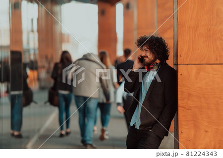 Happy young American holding a coffee. With headphones. Student boy. 81224343
