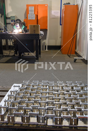 The first phase of metal and aluminum processing. Processed products from CNC machines stacked on a pallet in a large modern factory The first phase of metal and aluminum processing. Processed products from CNC machines stacked on a pallet in a large modern factory 81225395