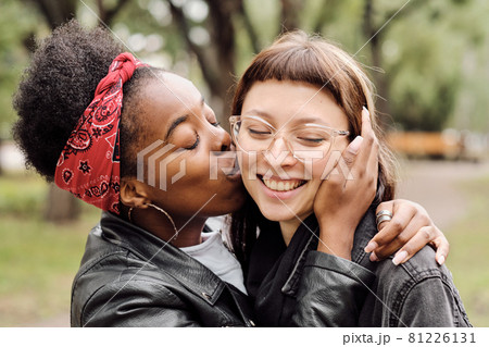 Amorous African female kissing her girlfriend on cheek Amorous African female kissing her girlfriend on cheek 81226131