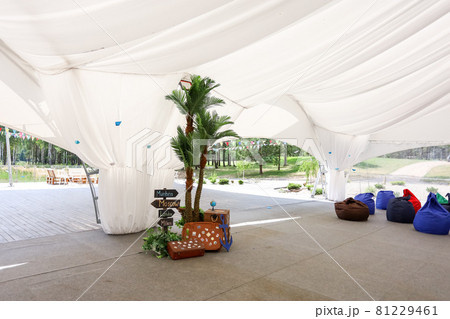 Soft beanbag chairs in an open-air tent 81229461
