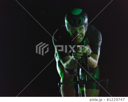 triathlon athlete riding bike at night 81229747