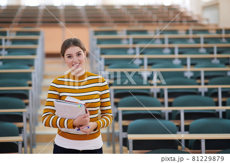 famale student using pen and notebook 81229879