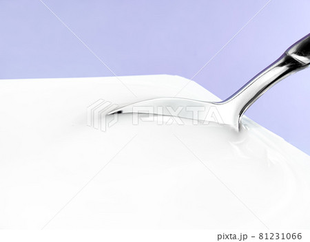 Yogurt cup and silver spoon on purple background, white plastic container with yoghurt cream, fresh dairy product for healthy diet and nutrition balance Yogurt cup and silver spoon on purple background, white plastic container with yoghurt cream, fresh dairy product for healthy diet and nutrition balance 81231066