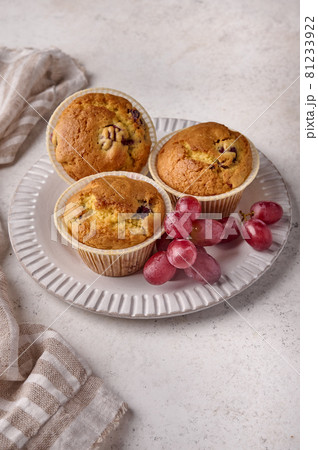 Vertical orientation cupcakes with cherries and grapes on plate with napkin Vertical orientation cupcakes with cherries and grapes on plate with napkin 81233922