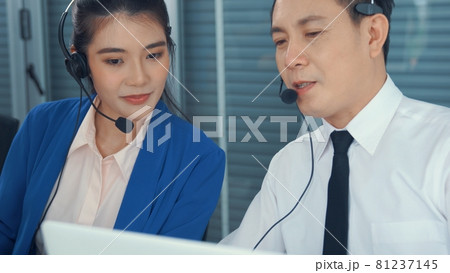 Business people wearing headset working actively in office 81237145