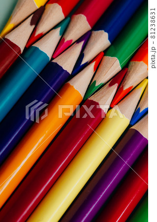 Colored sharpened pencils lie in a row close-up. Solid abstract background of wooden multi-colored Colored sharpened pencils lie in a row close-up. Solid abstract background of wooden multi-colored 81238631