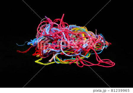 Multicolored tangled threads for needlework close-up on black background Multicolored tangled threads for needlework close-up on black background 81239965