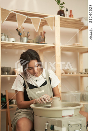 Potter with professional tools working in studio Potter with professional tools working in studio 81240628