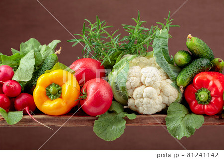 Various fresh raw vegetables on a brown background, copy space. 81241142