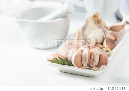 Fresh garlic bulbs with rosemary. Fresh garlic bulbs with rosemary. 81241153