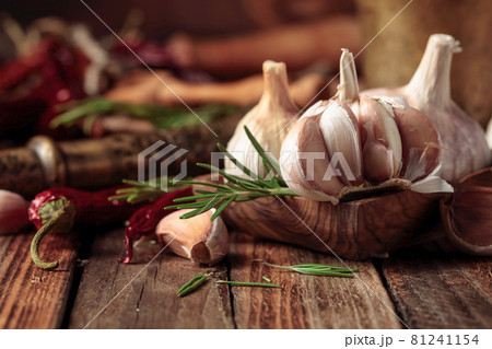 Fresh garlic bulbs with rosemary and red pepper. Fresh garlic bulbs with rosemary and red pepper. 81241154