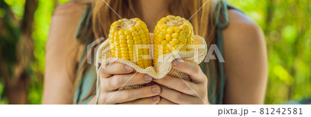 Corn in a reusable bag in the hands of a young woman. Zero waste concept BANNER, LONG FORMAT Corn in a reusable bag in the hands of a young woman. Zero waste concept BANNER, LONG FORMAT 81242581