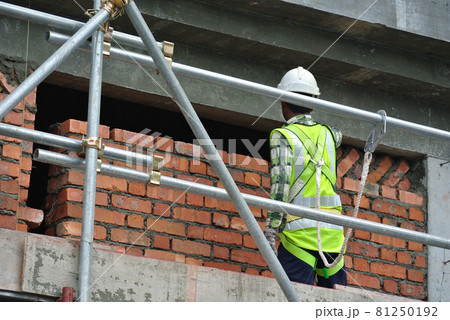 JOHOR, MALAYSIA -JUNE 28, 2016: Bricklayer lay clay bricks to form building walls at the construction site.  81250192