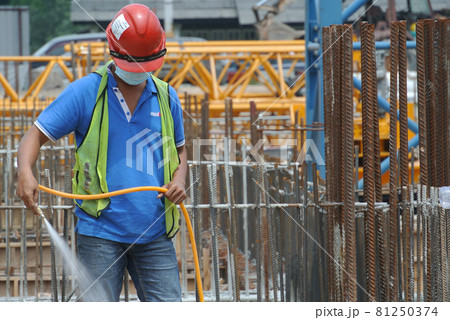 JOHOR, MALAYSIA -MARCH 29, 2016: Construction workers spraying the anti termite chemical treatment to the soil at the construction site. JOHOR, MALAYSIA -MARCH 29, 2016: Construction workers spraying the anti termite chemical treatment to the soil at the construction site. 81250374