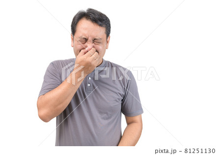 Man covers nose with hand, smells something awful Man covers nose with hand, smells something awful 81251130