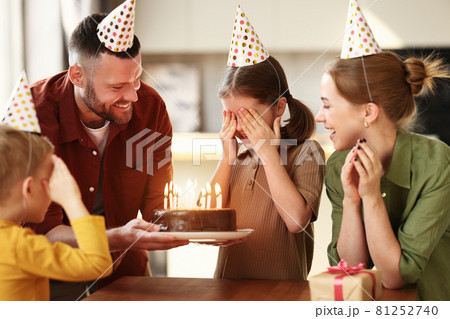 Cute little girl making wish while celebrating Birthday with family at home Cute little girl making wish while celebrating Birthday with family at home 81252740